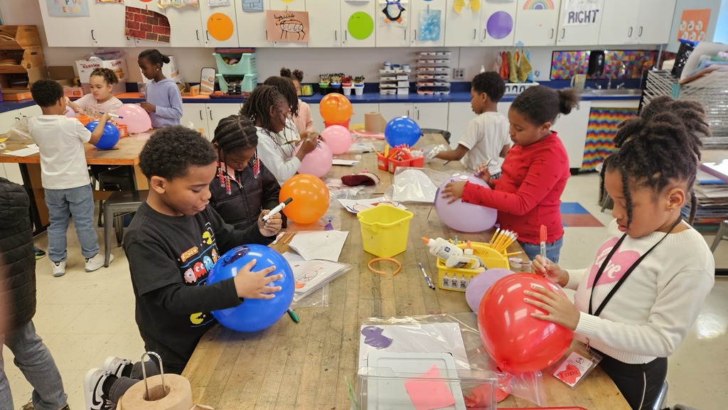 Students work on their balloons during art class.