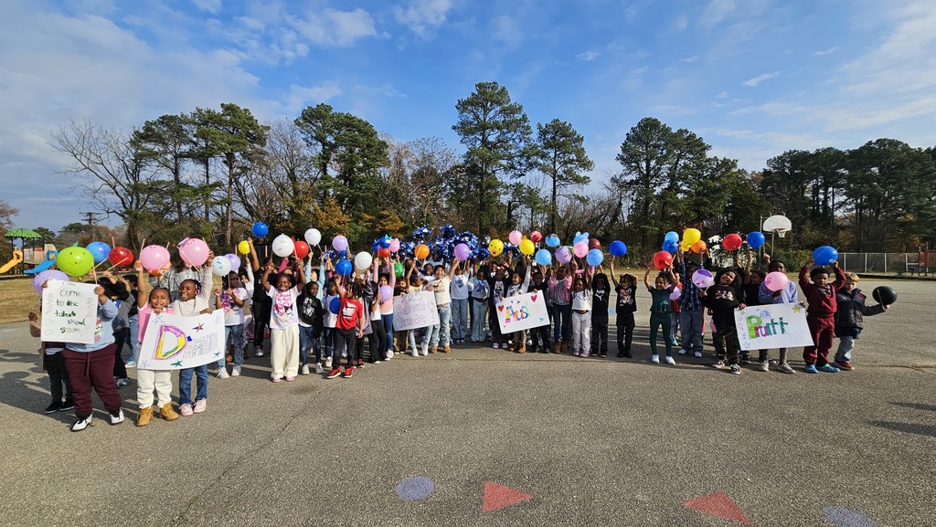 Students all show their balloons at the end of the parade.