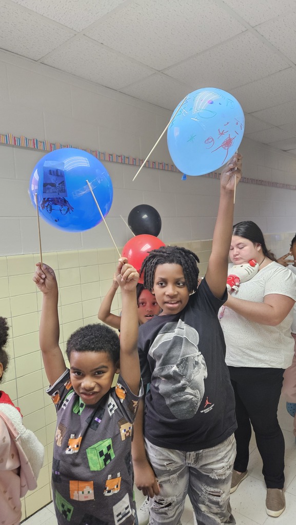 Students hold up their balloons in the parade.