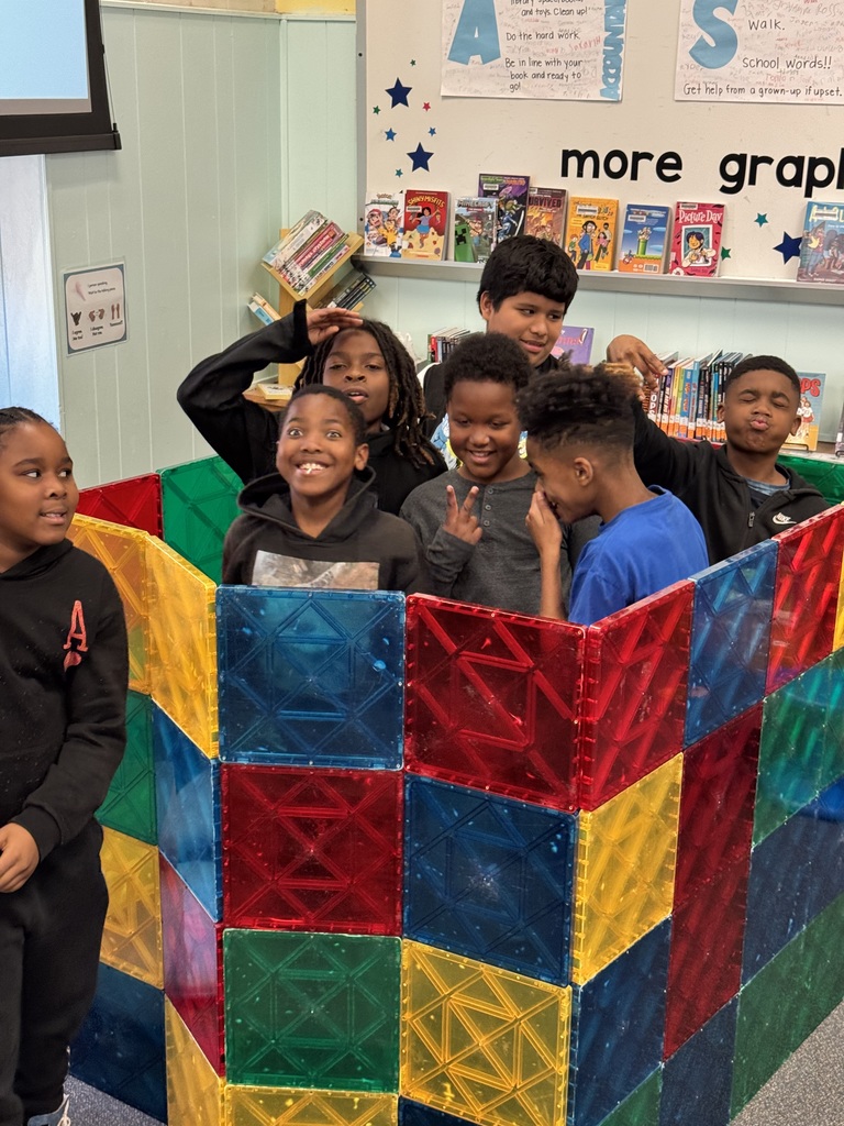 Fifth graders collaborate to build with Magnet Tiles.