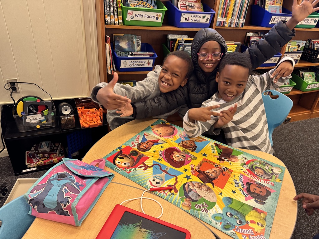 Students celebrate completing a puzzle together.