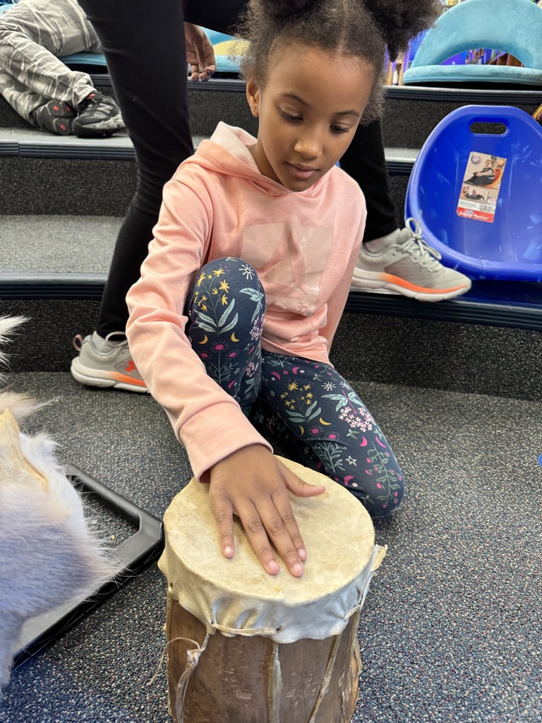 Student pretends to use a drum.