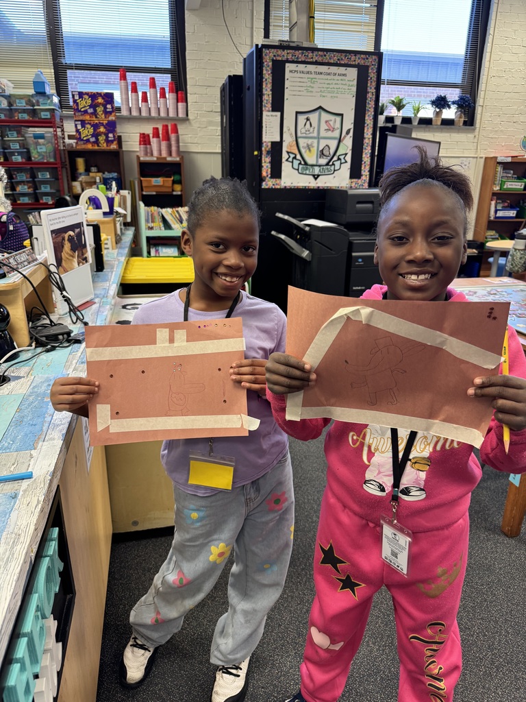 Students show off their Dogman artwork.