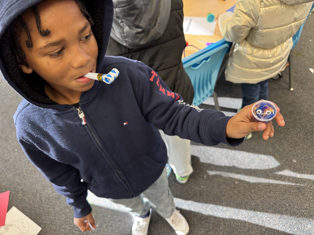 Student shows off his slime and party blower from the cart.