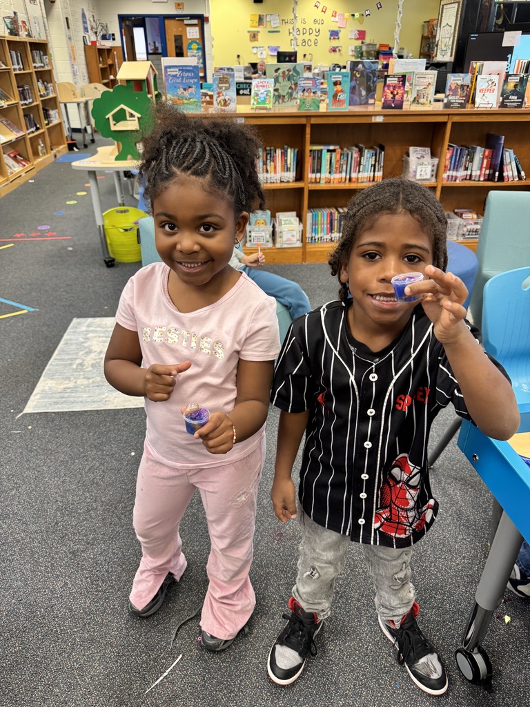 Two students show off the slime they purchased.