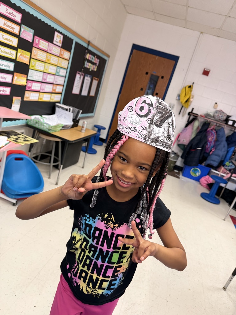 A student celebrates her 67th day with a hat and a smile.