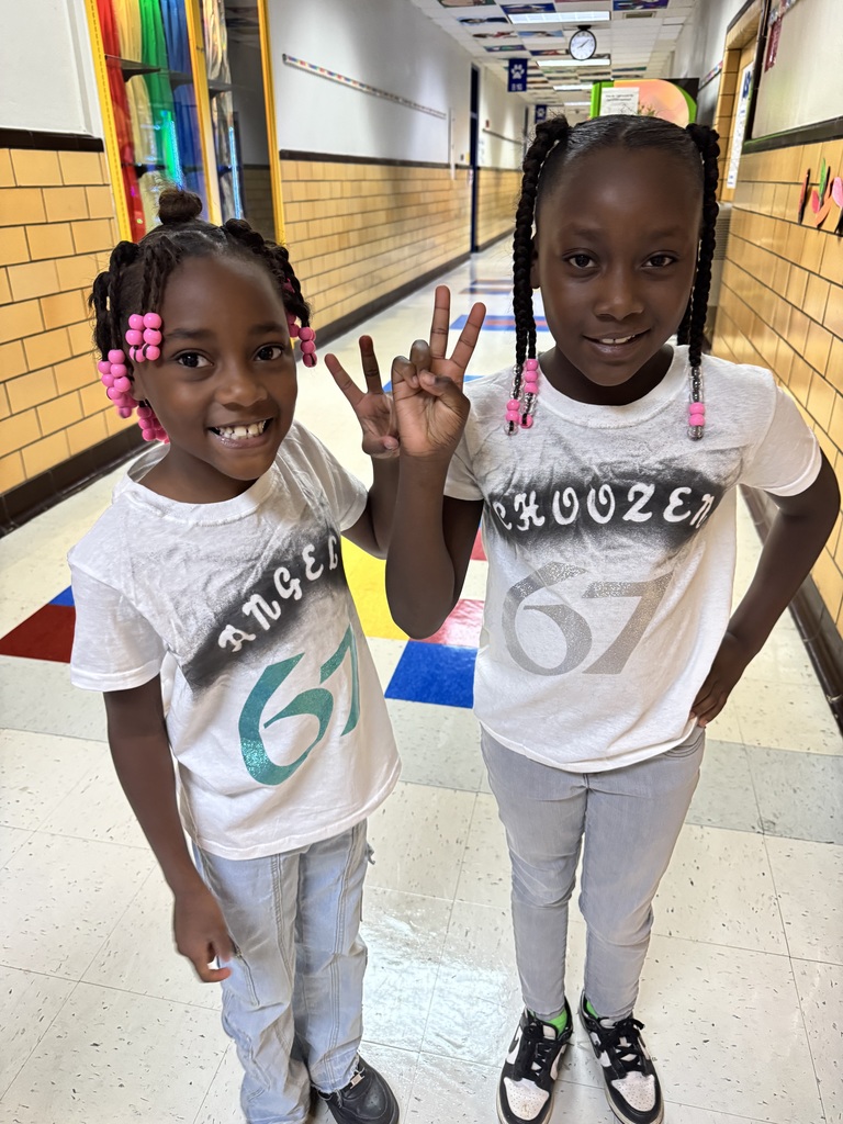 Two students show off their 67 shirts.