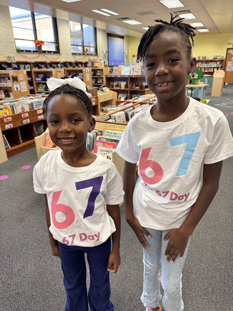 Two students show off their 67 day shirts.