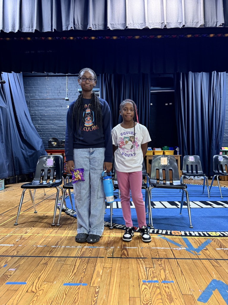 The spelling bee winner and runner up stand side by side.