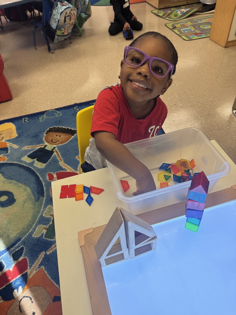 A student makes shapes on the light table.