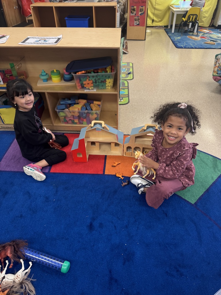 Students act out parts of the story during dramatic play.