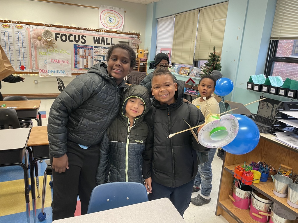 Students show their design to the camera.