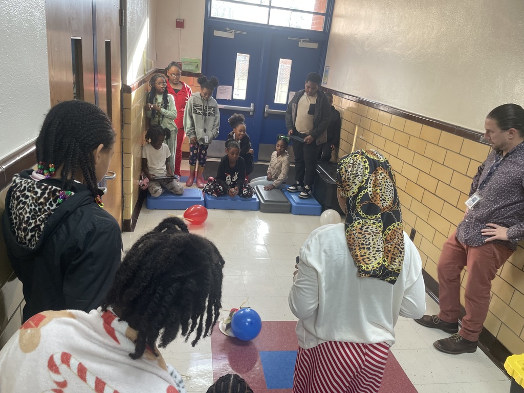 Students watch the BattleBots competition.