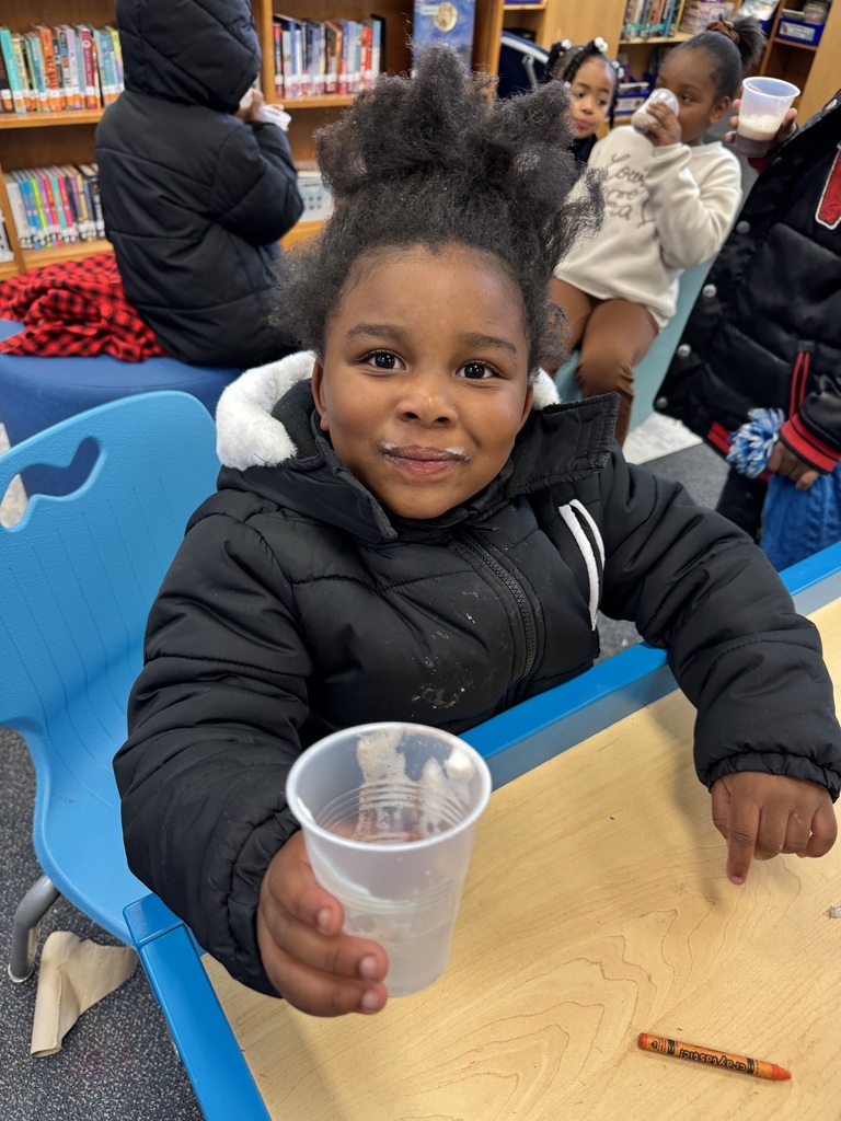 Student shows off their cup of hot cocoa.