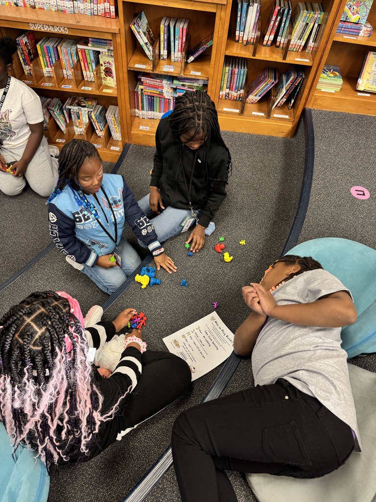 Students play the dreidel game together.
