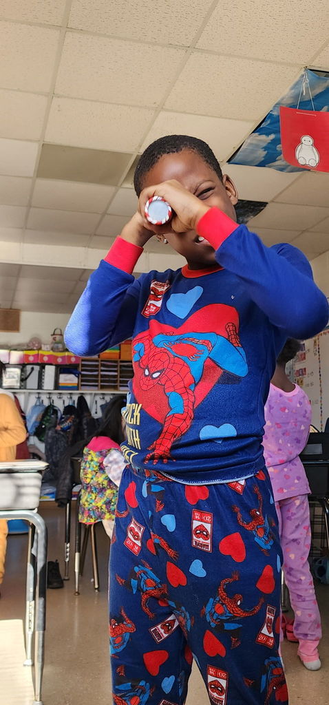 Student looks through a kaleidoscope.