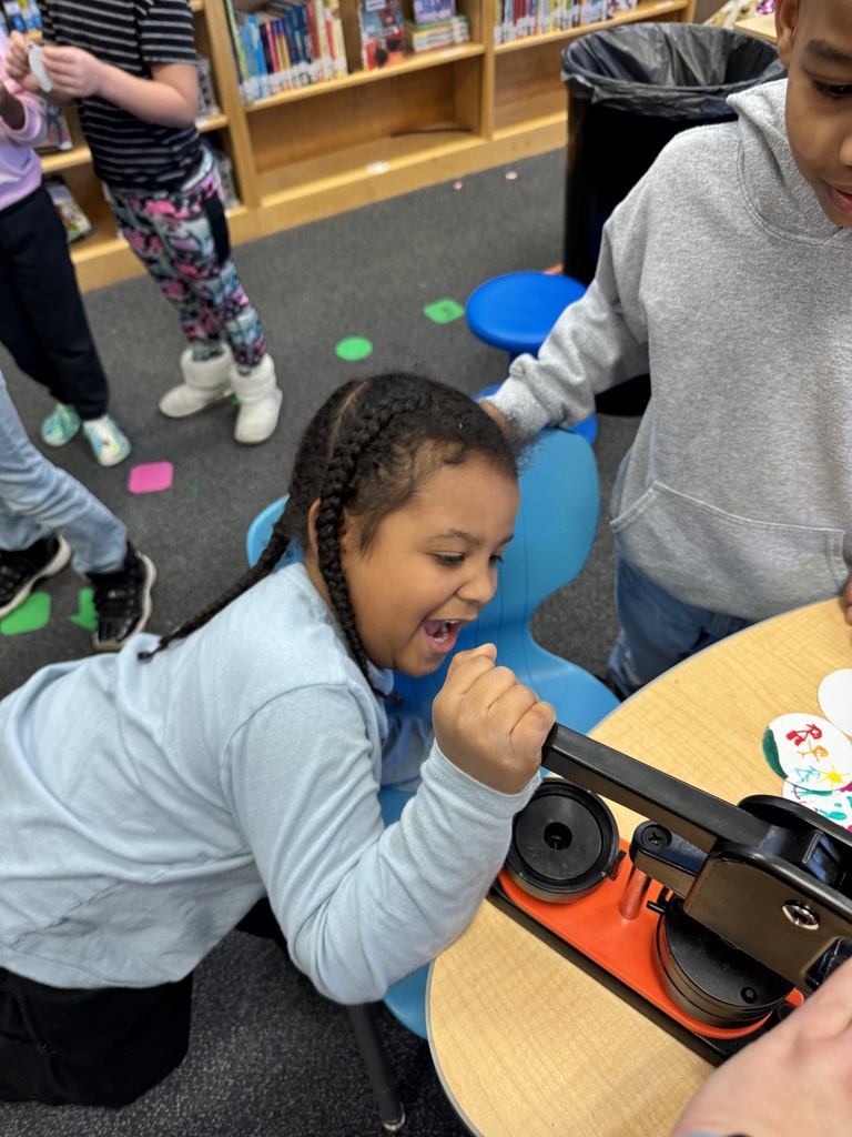A student makes a button.