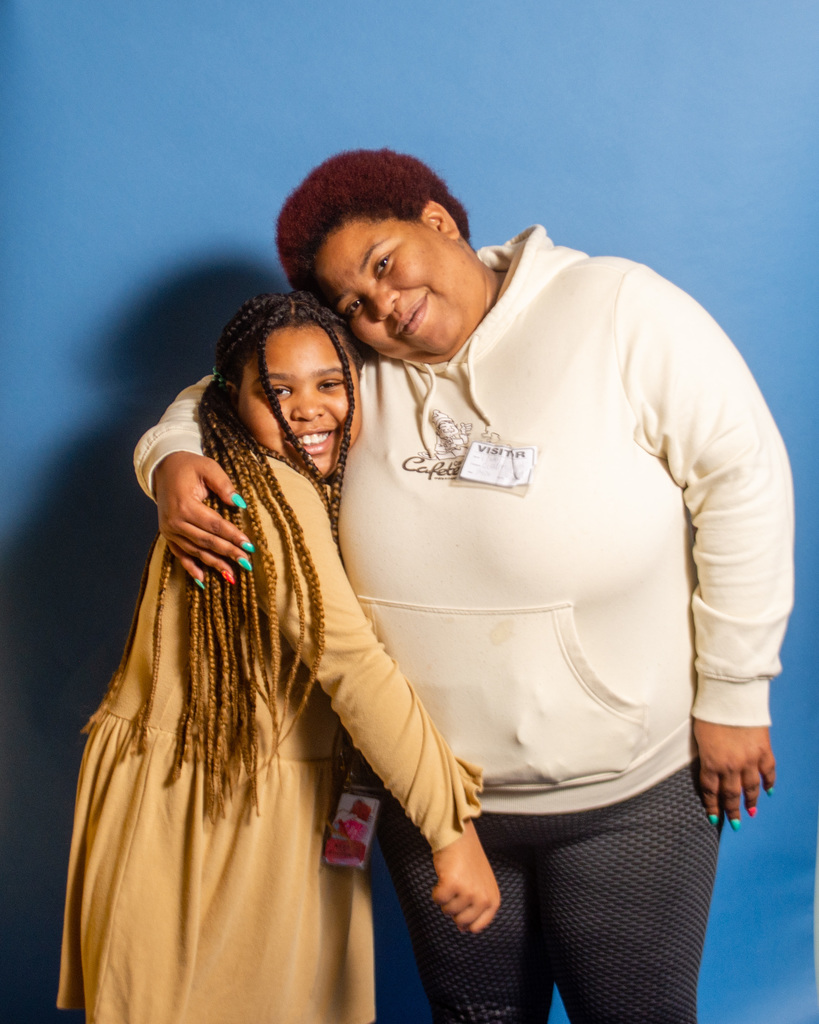 Student smiles with their family.