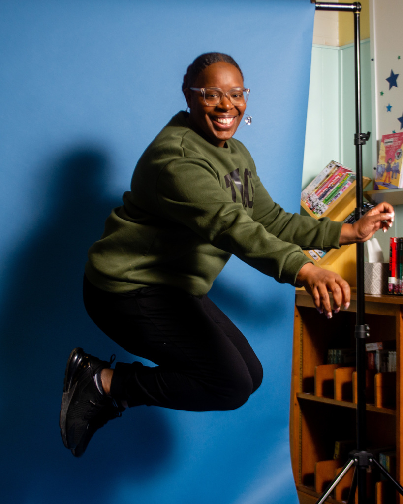 Teacher does a jumping shot for student photographers.