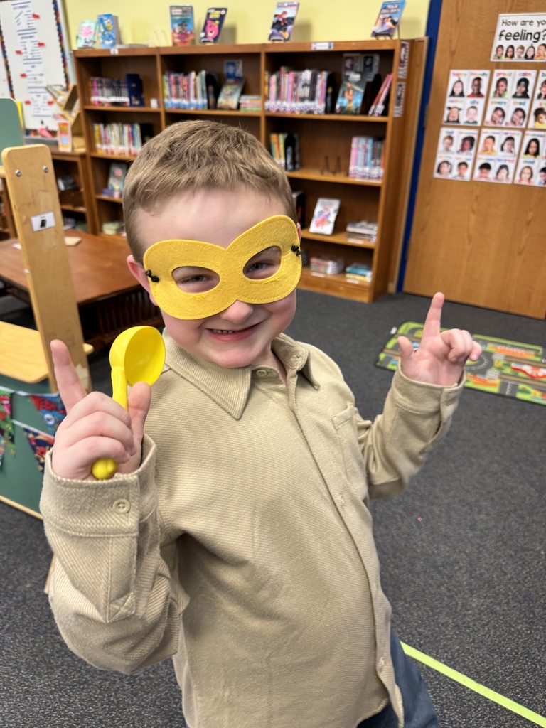 Student poses as a superhero.