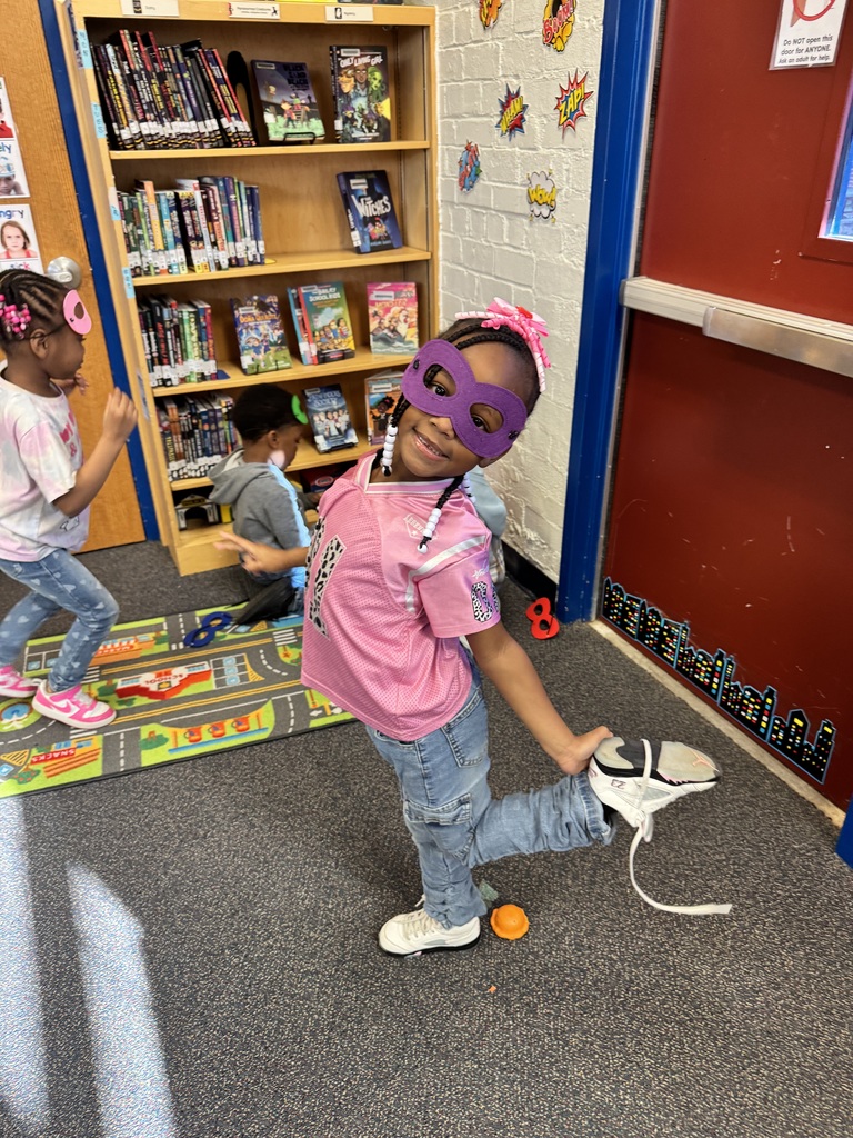 Student poses as a superhero.
