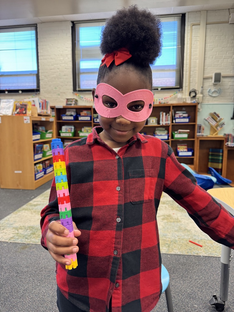 Student poses as a superhero with a tool.
