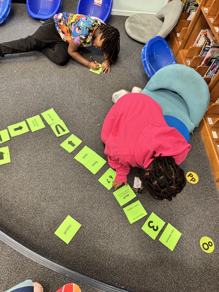 Students use cards to create a coding hopscotch.