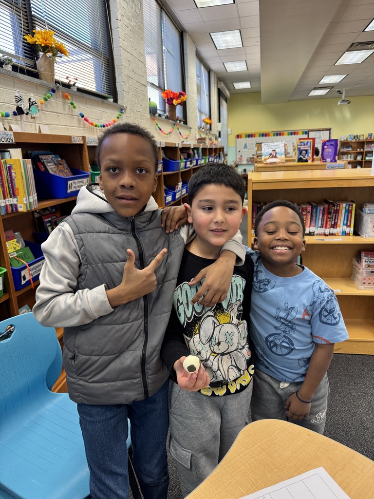 Students showcase another student who created a soccer ball.