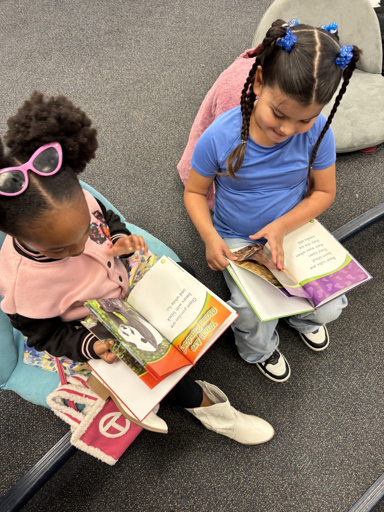 Students flip through their books together.