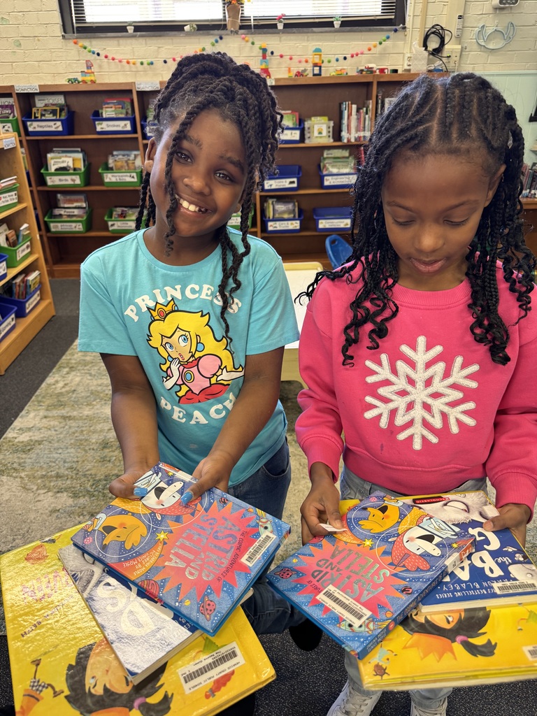 Students show off their new books.