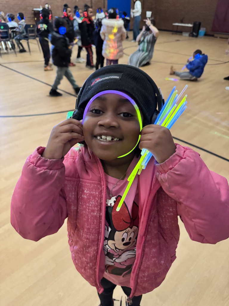 Students shows off glow sticks while dancing.