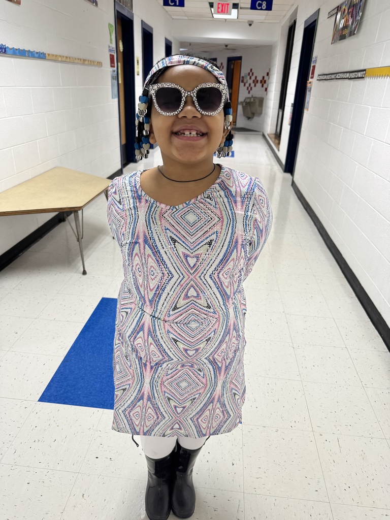 Student smiles in the hallway.