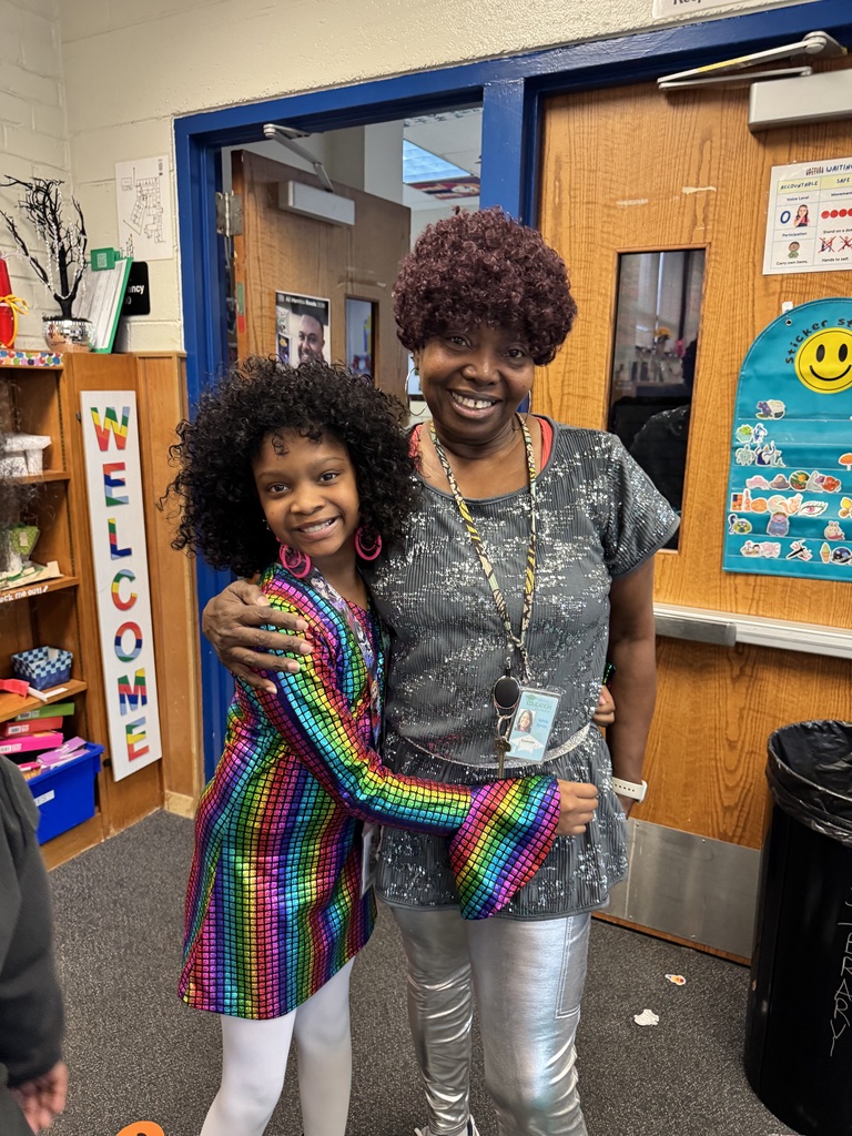 Staff and student hug each other for a picture.