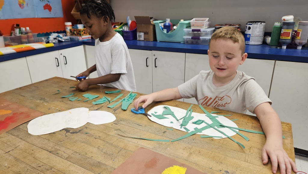 Kinder students work on their pumpkin collages.