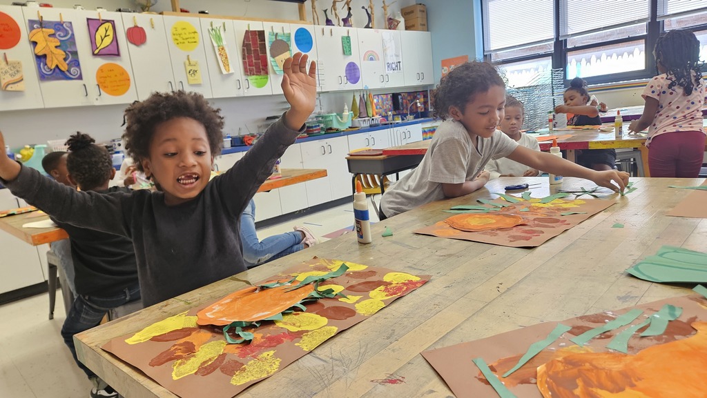 Kindergarten student shows off his work.
