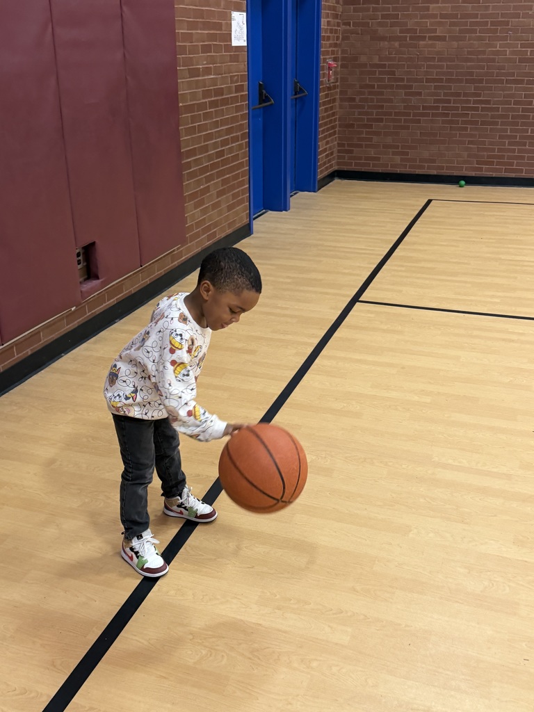 Student dribbles a basketball.
