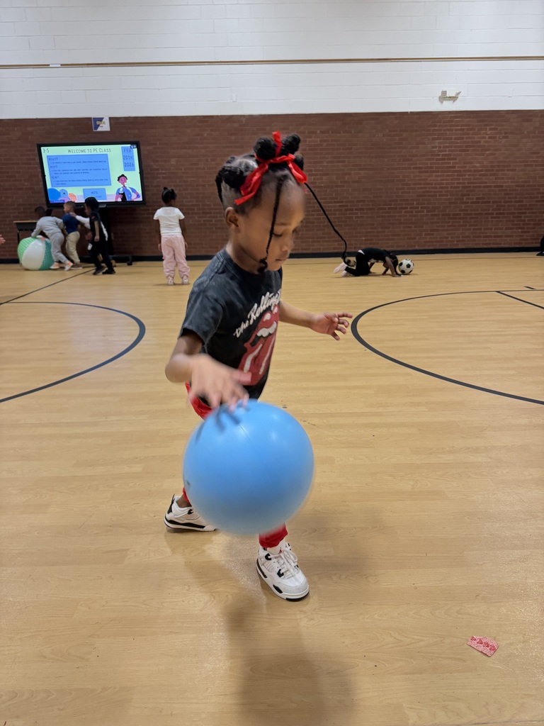 Studen dribbles a blue ball.