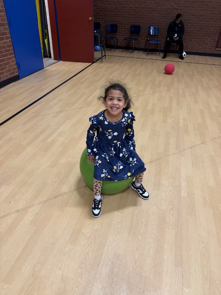 Student sits on a green ball.