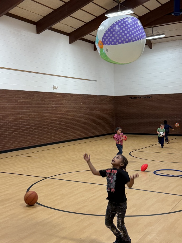 Student throws a ball very high into the air.
