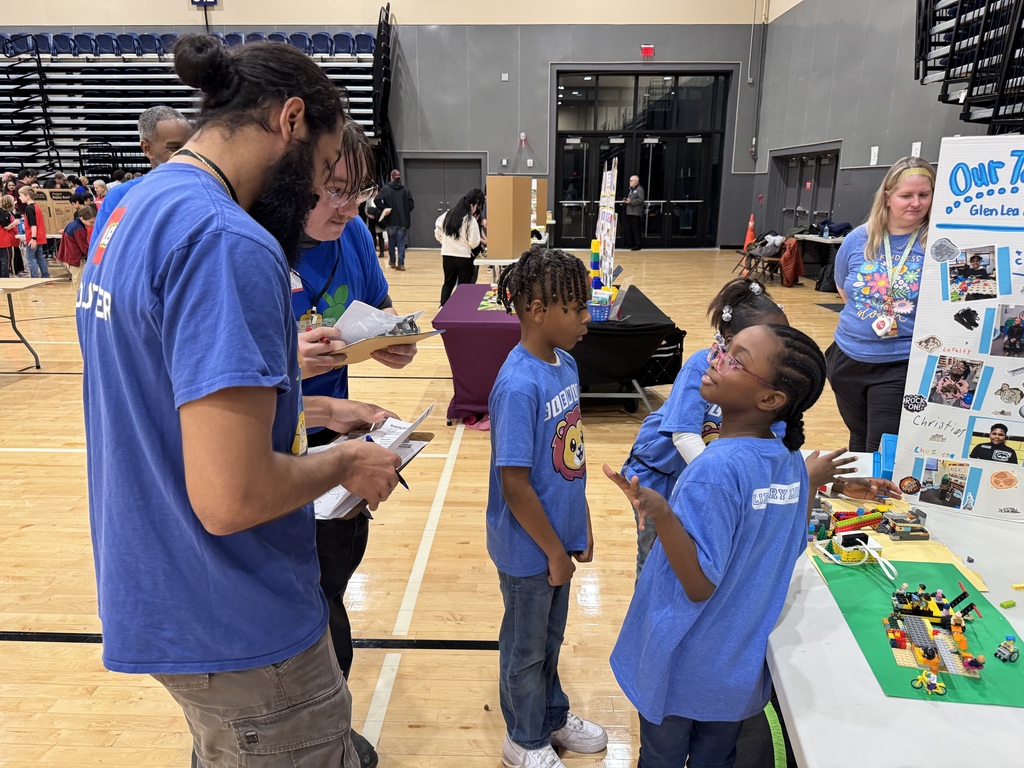 Students share about their Lego work with the guides.
