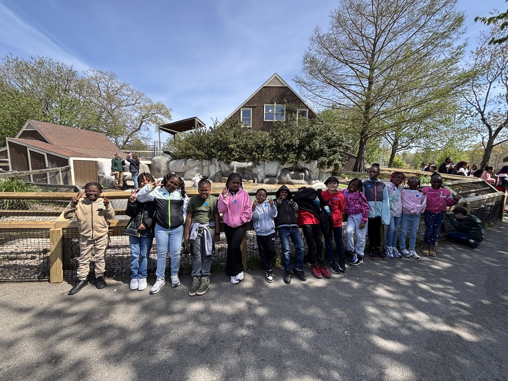 Students stand together as a class to take a picture.
