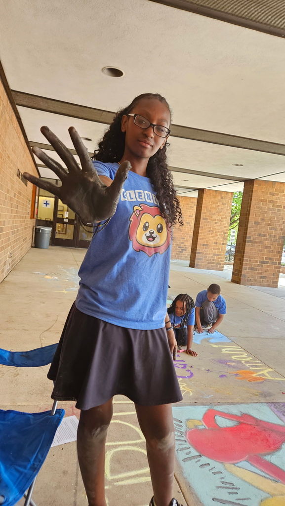 Student shows chalk paint on the hand.