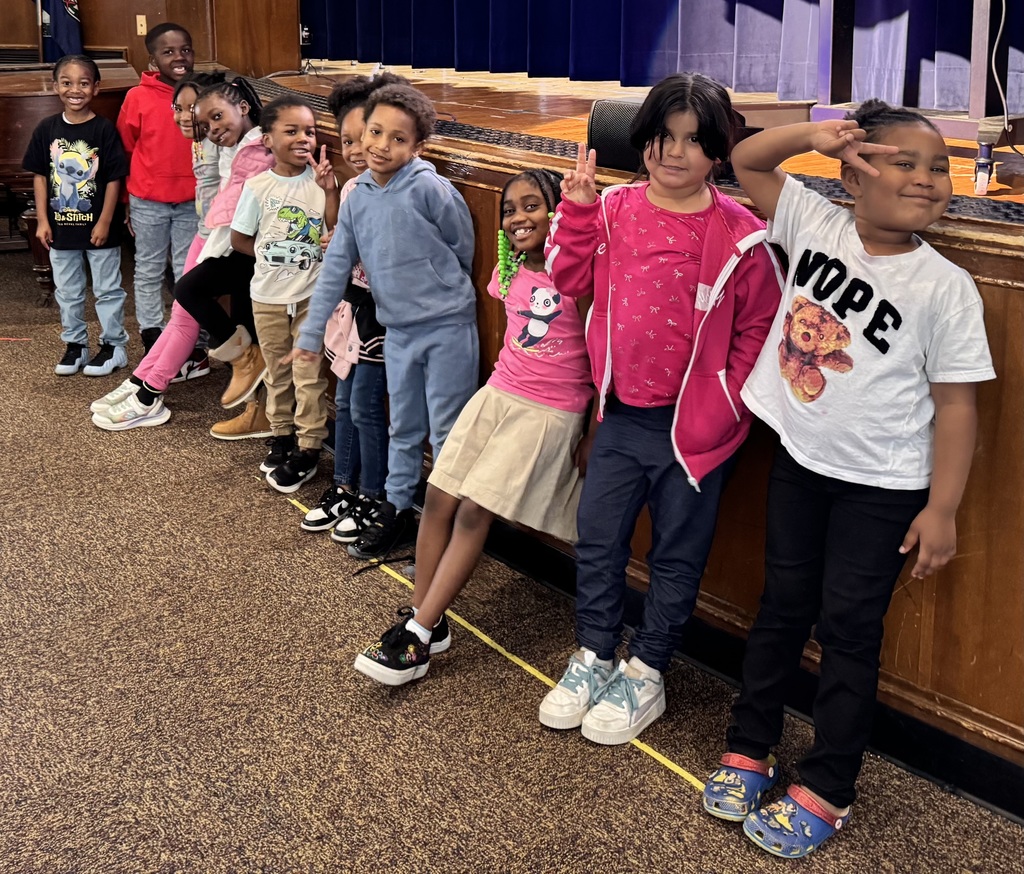 Student show their smiles as they stand for their awards.