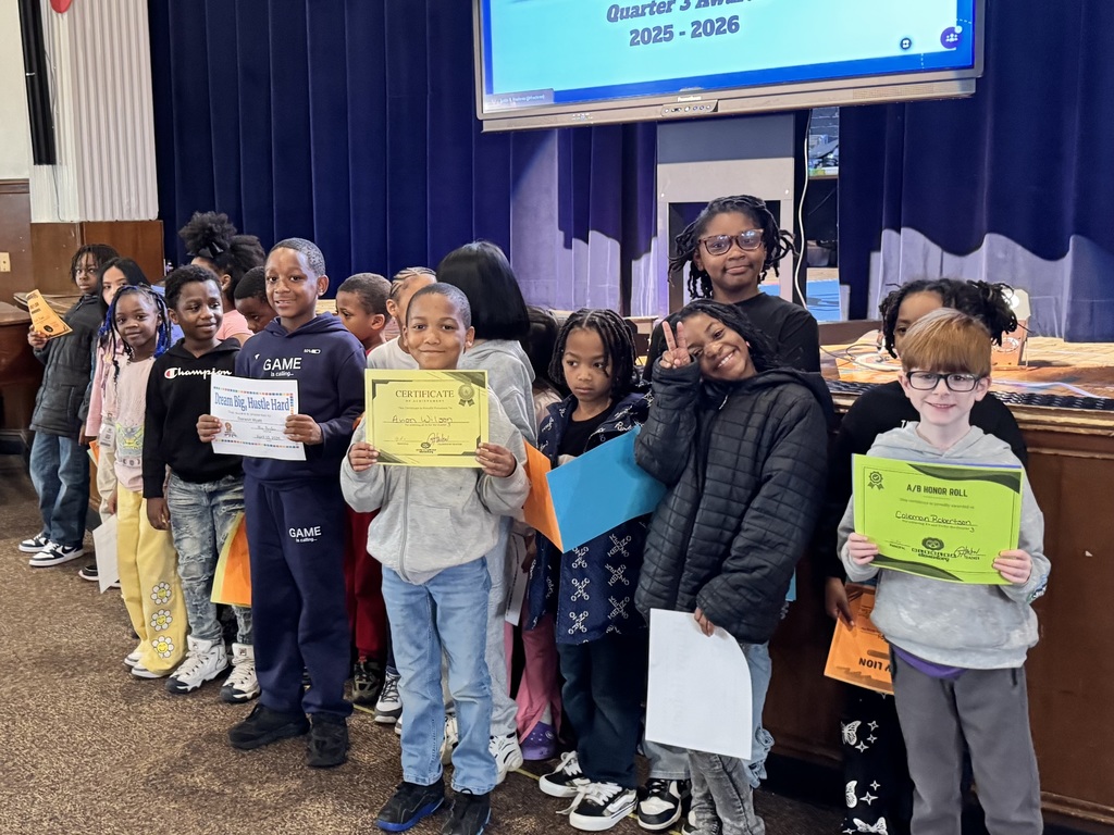 Student show their smiles as they stand for their awards.