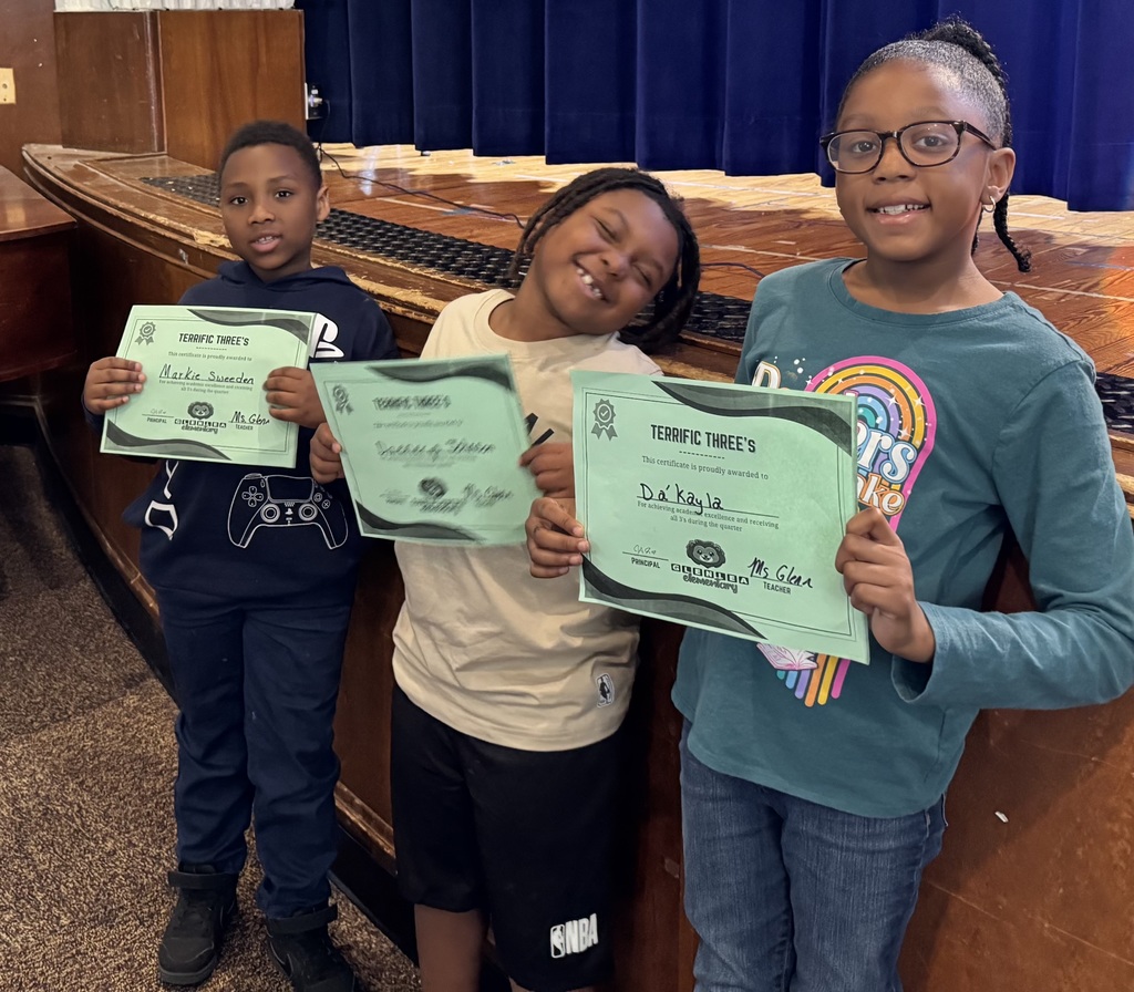 Student show their smiles as they stand for their awards.