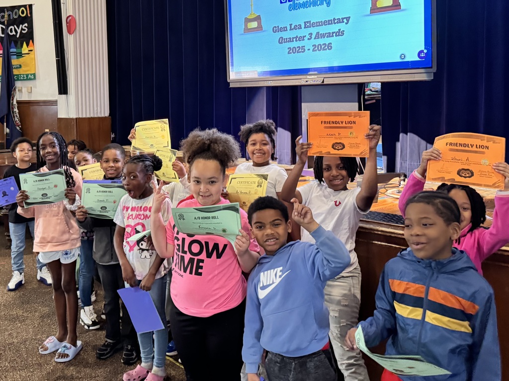 Student show their smiles as they stand for their awards.