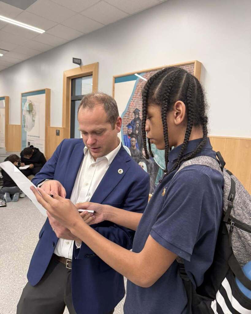 student interacting with community member during 100 Men Day Sept. 17, 2026