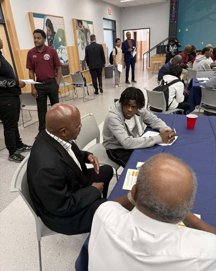 student interacting with community member during 100 Men Day Sept. 17, 2026