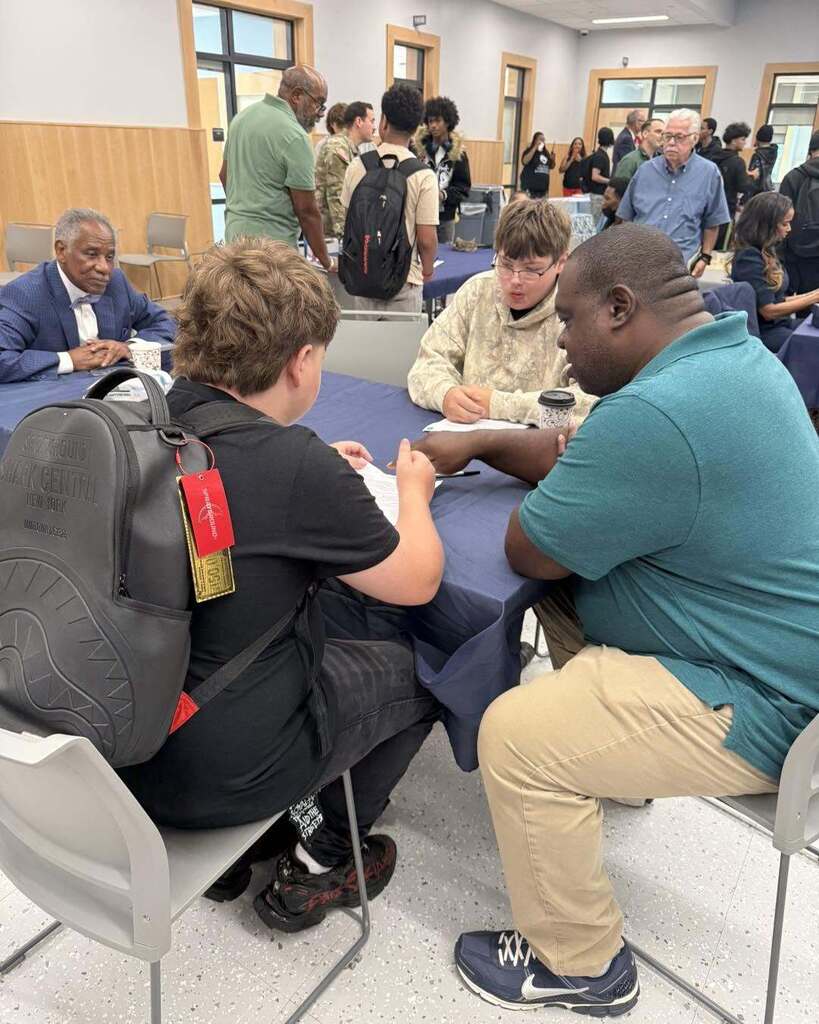 Students interacting with community members for 100 Men Day Sept. 17, 2026.