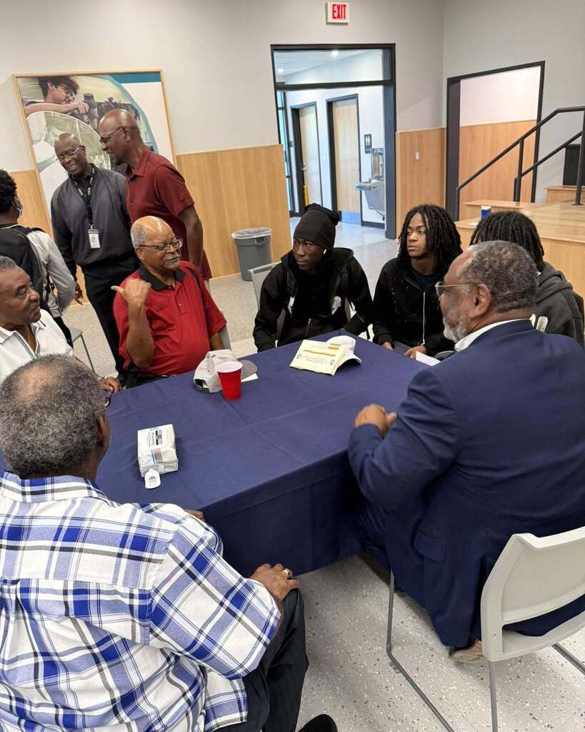students interacting with community member during 100 Men Day Sept. 17, 2026
